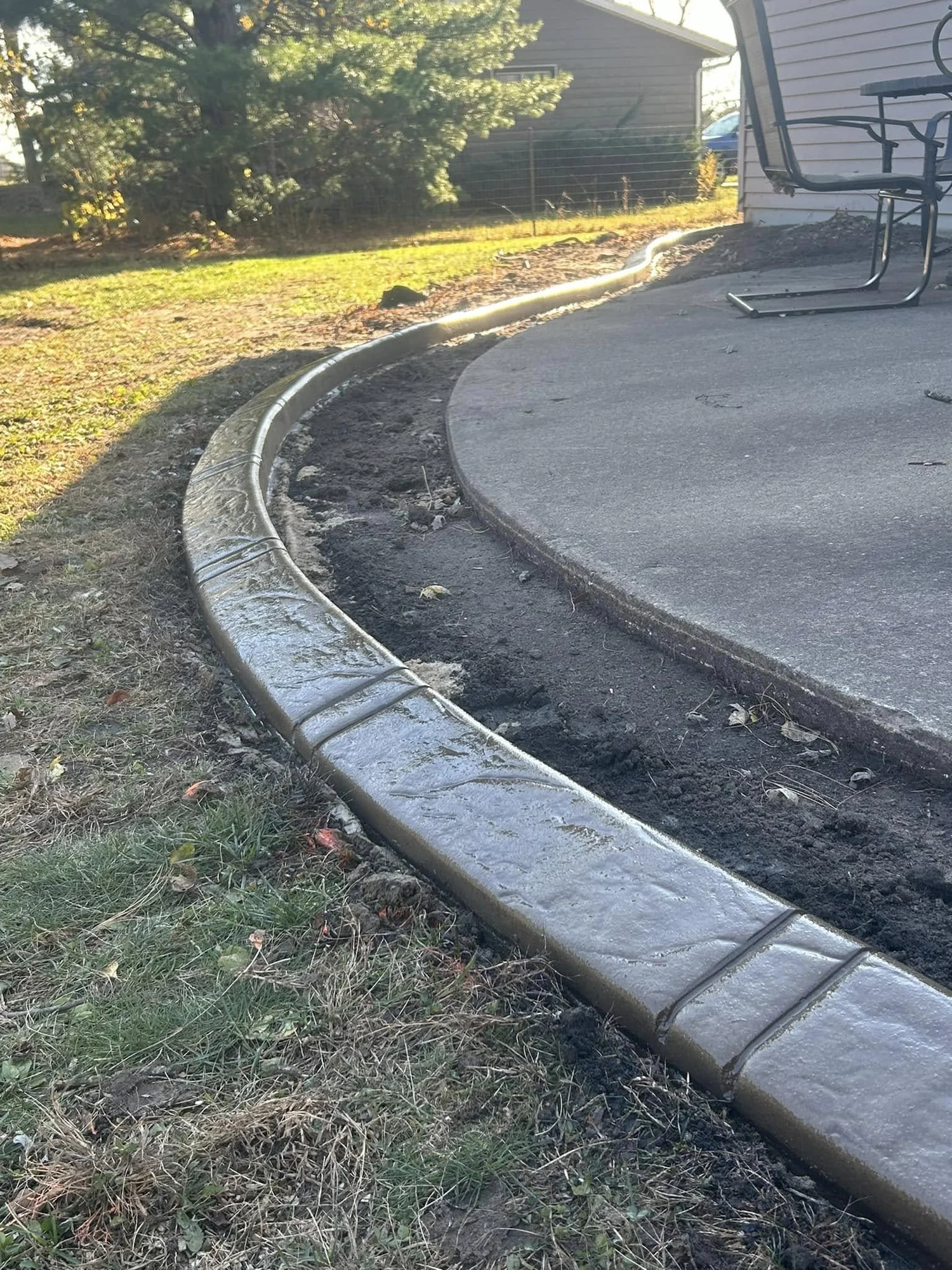 Curved decorative curbing along driveway